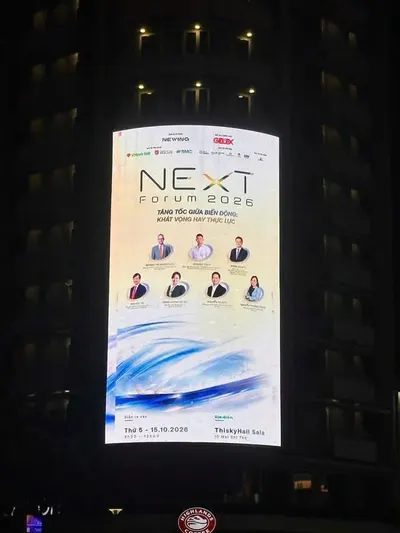 Partner LED screen showing the NExT Forum 2026 poster at night